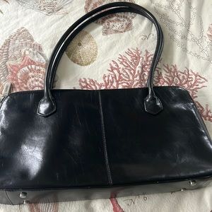 HOBO black leather shoulder bag. Red liner with several pockets.